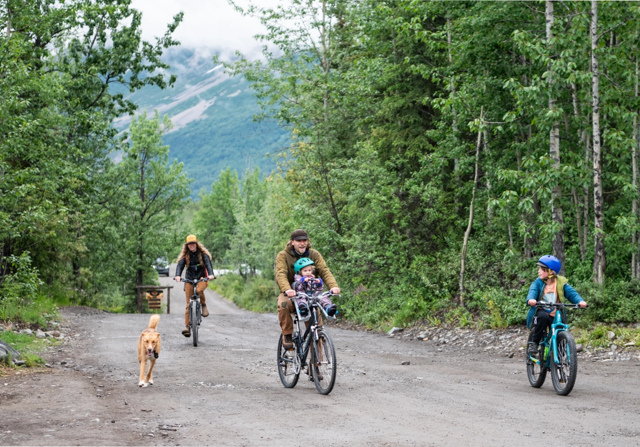 Cycling with dog and family in a public park